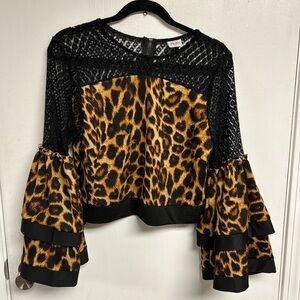 Unique leopard crop top with lace detailing, zippered back.  Double bell sleeves